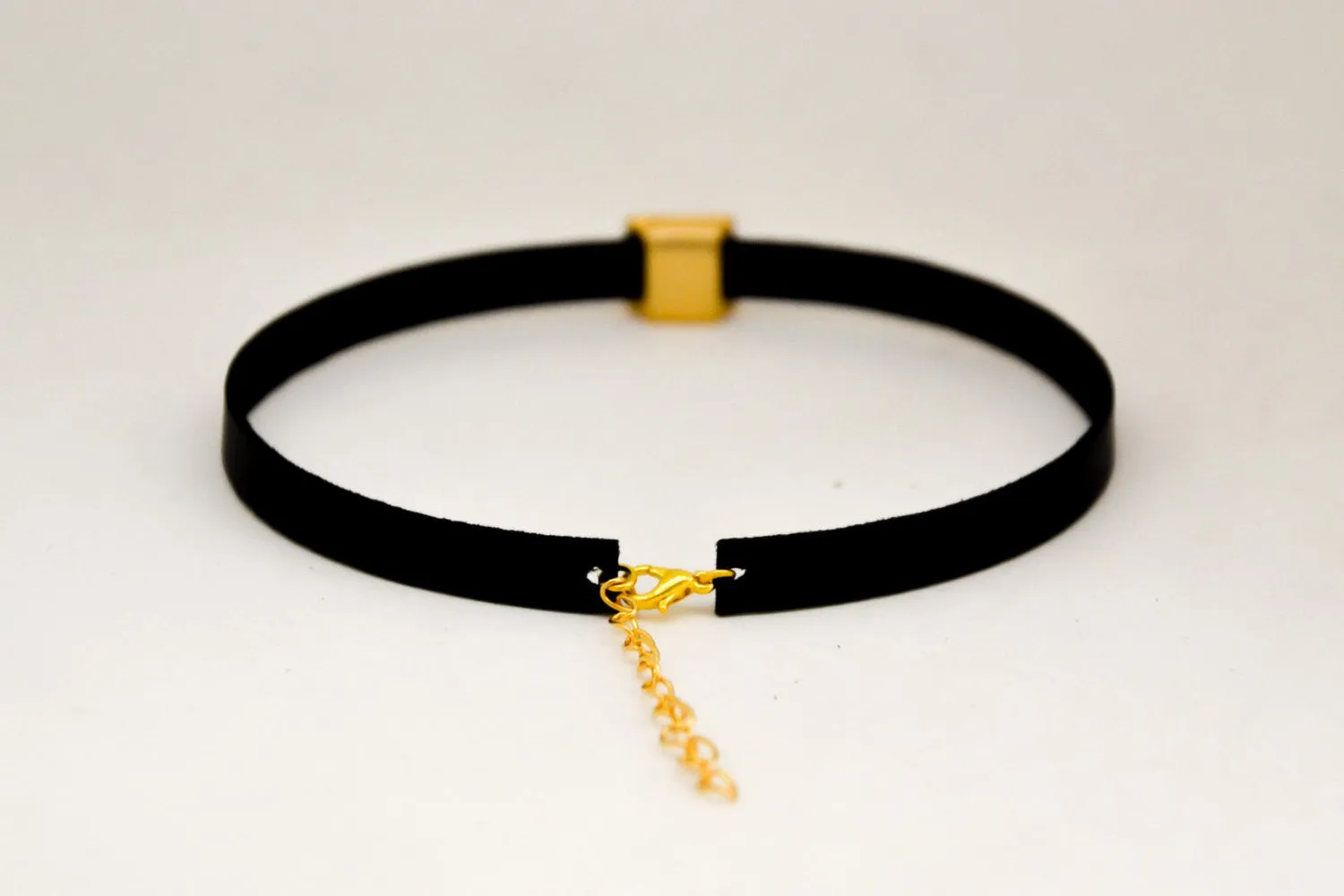 Choker necklace with a gold pyramid bead